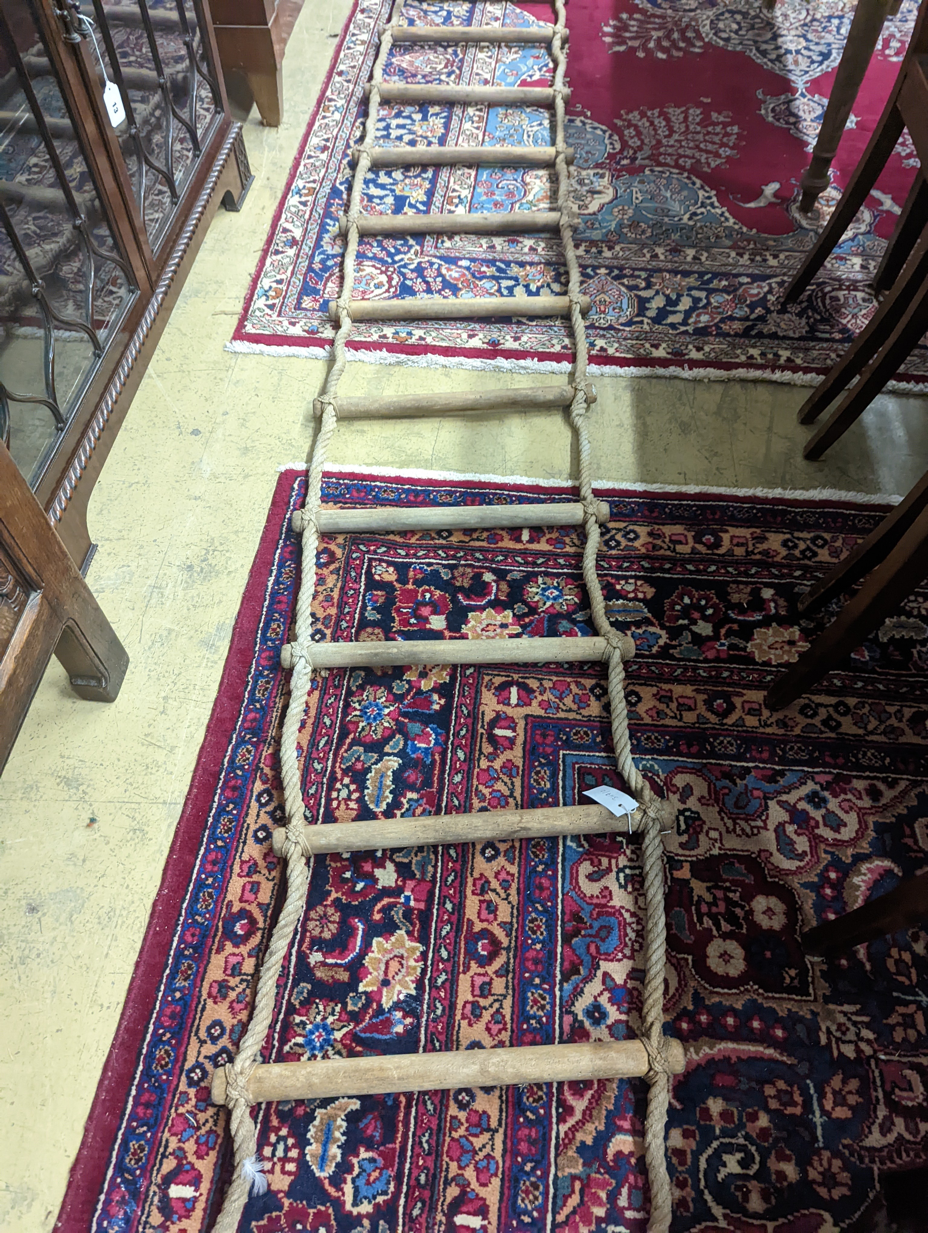 A rope ladder, Length 3.9 meters. (1 lower rung damaged)